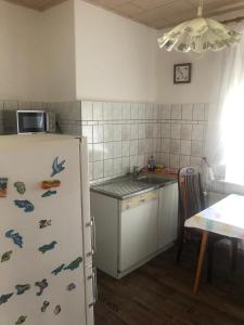 a kitchen with a refrigerator with fish magnets on it at Schöner Wohnen in Senzig bei Berlin 2 in Senzig