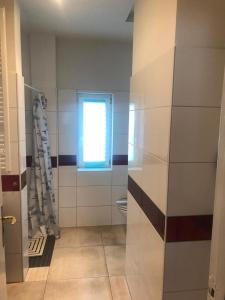 a bathroom with a toilet and a window at Schöner Wohnen in Senzig bei Berlin 2 in Senzig