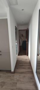 an empty hallway with white walls and a wooden floor at Bel appartement sur le port du Brusc avec sa place de parking privative. in Six-Fours-les-Plages