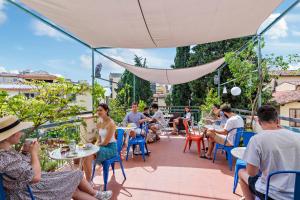 a patio area with tables, chairs and umbrellas at Hotel Azzi in Florence
