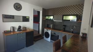 a kitchen with a table and a sink and a dishwasher at Coeur de ville, calme, spacieux,Parking et wifi ! in Chartres