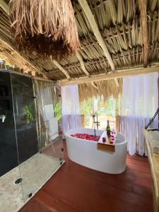 a bathroom with a bath tub in a room at Nuscaa Boutique Tree House & Spa in Puerto Morelos