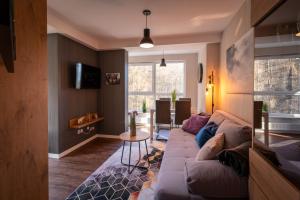 a living room with a couch and a table at Apartament Kurort Kozubnik Wilcza Wataha in Porąbka