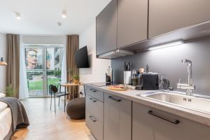 a kitchen with a sink and a counter top at Limehome Münster Von-Steuben-Str - Digital Access in Münster
