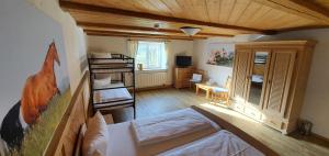a room with a bed and a living room at Allgäu Meadow Ranch in Hergatz