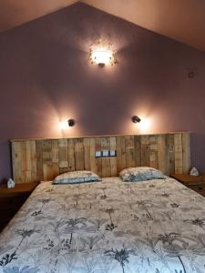 a bedroom with a large bed with a wooden headboard at Quinta Cunte - Casa Sobreiro in São Luis +22 photos
