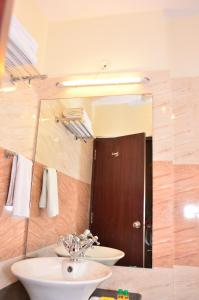 a bathroom with a sink and a mirror at Raj Regency in Jaipur +19 photos