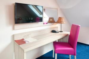 Televízia a/alebo spoločenská miestnosť v ubytovaní Hotel Petrus