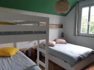 Ce lit se trouve dans un dortoir doté de 2 lits superposés et d'un plafond vert. dans l'établissement Maison en bord de mer, à Blonville-sur-Mer