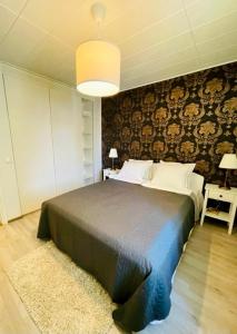 a bedroom with a large bed in a room at Ilona Apartments - "The City Condo" in Kotka