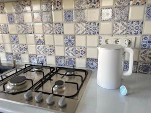 a kitchen with a stove top with a jug on it at Express Inn in Poti