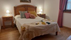 a bedroom with a bed with stuffed animals on it at Apartamentos El Haya in Cosgaya