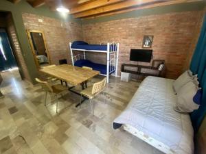 a bedroom with a bed and a dining room with a table at Apart Conector Sur in San Juan