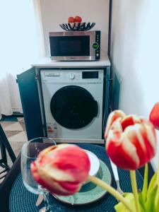 a table with a bowl of fruit and a microwave at Apartment One Brasov in Braşov