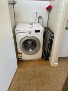 a washer and dryer in a corner of a room at Close to Coast & Bellarine Peninsula in Moolap