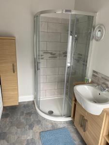 a bathroom with a shower and a sink at Dympna's City Centre apartment, Armagh in Armagh