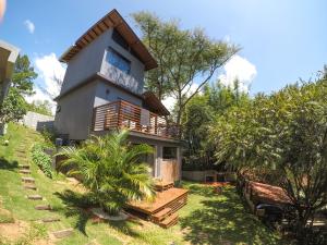 a house in the middle of a yard with trees at Pousada Refúgio do Vale - Praia do Rosa in Praia do Rosa