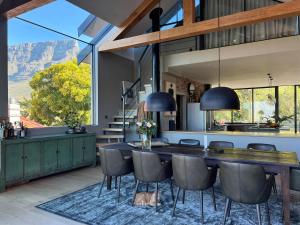 a kitchen and dining room with a table and chairs at Luxurious Loft Living in Cape Town
