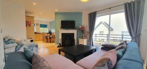 a living room with a blue couch and a fireplace at Shallow Sea-Point in Knights Town