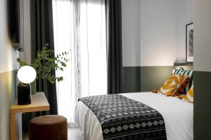 Postel nebo postele na pokoji v ubytování Doña Lola Alojamientos Boutique