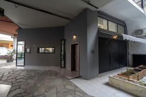 a home with a stone patio and a building at City Center Ground Loft - Ioannina in Ioannina