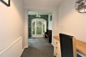 
a living room with a staircase leading to a hallway at Central Serviced Apartments by Roomsbooked in Cheltenham
