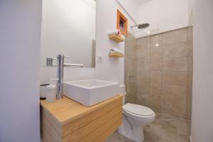 a bathroom with a white toilet and a sink at No 22 Riders' Inn in Akyaka