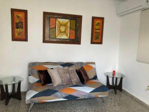 a living room with a couch and two tables at The Little Blue House in Guayama +15 photos