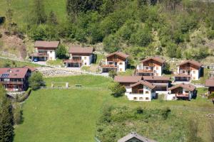 an aerial view of a house in a mountain at Ferienpark Schöneben in Wald im Pinzgau