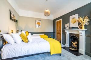 a bedroom with a bed with yellow and white pillows at 46 Nunnery Lane in York