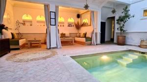 a pool in the middle of a living room at Riad Alizé in Marrakesh