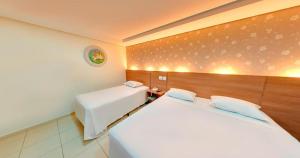 a hotel room with two beds in a room at Amazon Plaza Hotel in Cuiabá