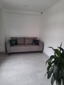 a living room with a couch and a table at 80Cooliving Medellín in Medellín
