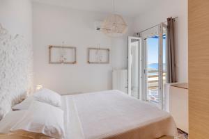 A bed or beds in a room at ENDLESS BLUE from Syros - Fabrika Resort