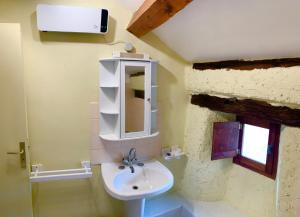 a bathroom with a sink and a mirror at Bedousses in Aujac