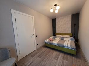 a small bedroom with a bed and a door at Апартаменты на Титова in Dnipro