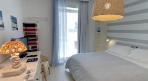 a bedroom with a bed and a table with a lamp at Malù Bed&Breakfast in Polignano a Mare