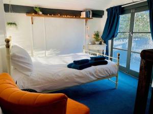 a bedroom with a bed and a couch in it at Outhouse Bothy in Kirkby Lonsdale