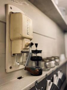 a kitchen counter with a coffee maker on a shelf at Outhouse Bothy in Kirkby Lonsdale