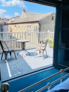 a view of a balcony with a table and chairs at Outhouse Bothy in Kirkby Lonsdale