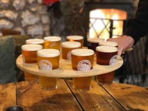 a tray ofints of beer on a wooden table at Outhouse Bothy in Kirkby Lonsdale +19 photos