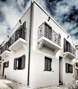 a white building with balconies on the side of it at ANGONI SUITES in Kardamaina