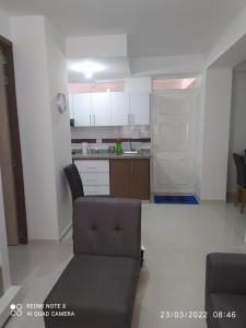 een woonkamer met een bank en een keuken bij Apartamento Loft in Bucaramanga