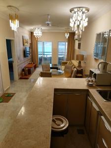 a kitchen and living room with a living room at Amwaj hotel Salalah Mirbat in Salalah