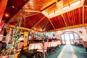a restaurant with tables and chairs and wooden ceilings at Ras Amba Hotel in Addis Ababa