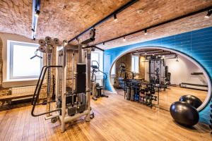 a gym with exercise equipment and a brick wall at TRIBE Riga City Centre in Rīga