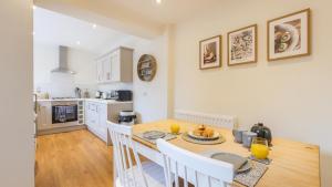 a kitchen and dining room with a table and chairs at The Roman Apartment in Hexham