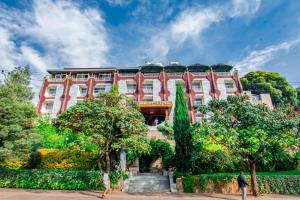 a red building with a train on top of it at Ras Amba Hotel in Addis Ababa