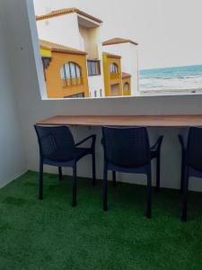 d'une table et de chaises sur un balcon donnant sur l'océan. dans l'établissement Agréable appart rénové vue mer 4 pers Parking Wifi, au Barcarès