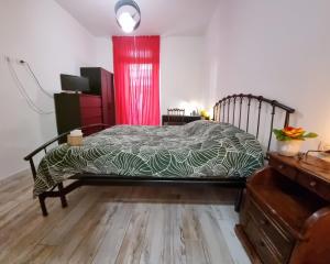 a bedroom with a bed and a red curtain at Kos in Florence